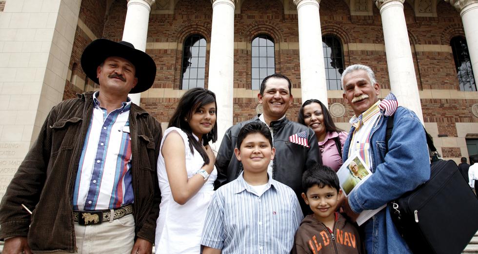 Mexican national Yulithza Ortiz (center) strands outside the Memorial Auditorium surrounded by family after his U.S. citizenship ceremony last month. 