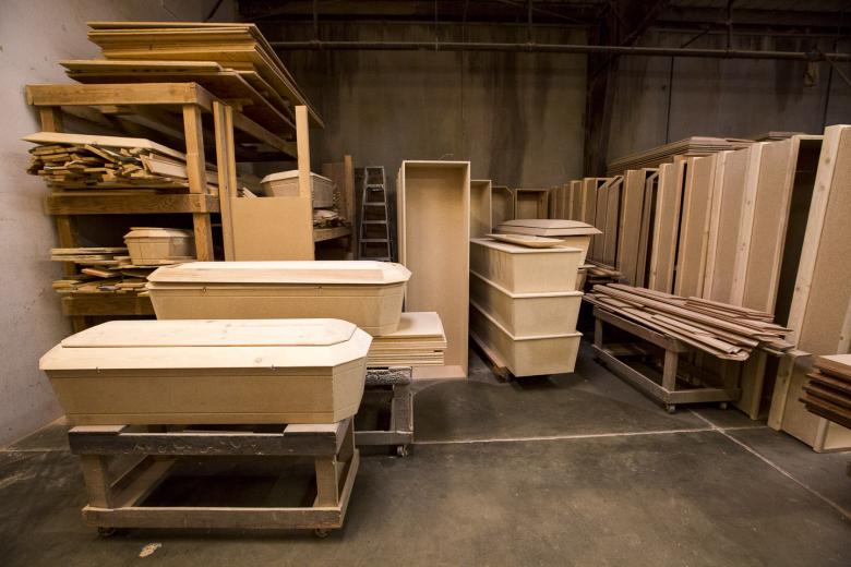 Pettigrew & Sons Caskets Co. makes custom caskets — which are rectangular in shape, distinguishing them from coffins, which are six-sided — out of their warehouse. Caskets in their showroom each have a personal story, like the one draped in red and purple fabric, inspired by the jersey of the deceased person’s favorite team. There’s also a casket with gold sequins and another with leopard print. Pettigrew & Sons Caskets Co. makes custom caskets — which are rectangular in shape, distinguishing them from coffins, which are six-sided — out of their warehouse. Caskets in their showroom each have a personal story, like the one draped in red and purple fabric, inspired by the jersey of the deceased person’s favorite team. There’s also a casket with gold sequins and another with leopard print.