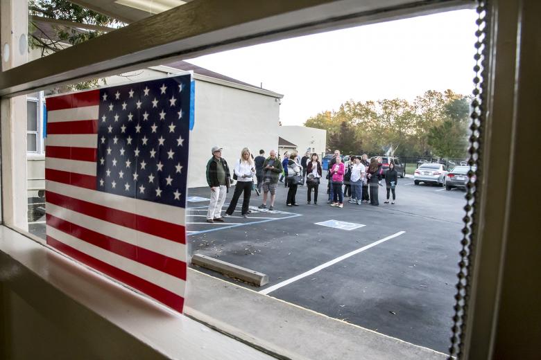 By 7 a.m., the line of voters has snaked around the side of the building and is about 50 deep.