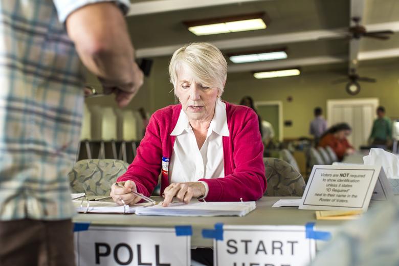 Poll worker Sue Staats checks in a voter at Poll A. The Sierra 2 Center is a dual voting place, serving two adjacent precincts in the greater Curtis Park area.