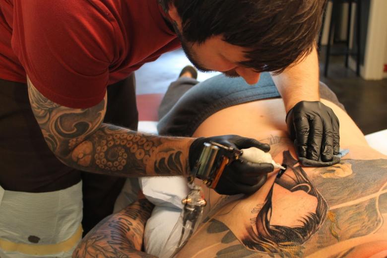 Tattoo artist and owner of Reclamere Custom Tattoo Corey Bernhardt working on a major piece. Tattoo artist and owner of Reclamere Custom Tattoo Corey Bernhardt working on a major piece.
