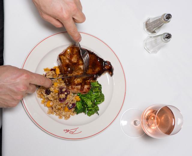 On Biba restaurant’s menu: Grilled Niman Ranch pork porterhouse cut with a balsamic vinegar glaze served with farro, butternut squash and radicchio.