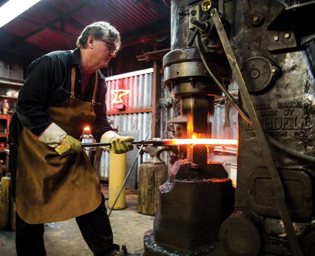 After years working with chainlink fence as part of the family business, Stephen Lyman opened Fence World in East Sacramento in 1978. The shop handles everything from simple cut-and-weld projects to custom black- and metalsmithing. While his staff works the larger, more structural elements, Lyman uses his artistry and attention to detail to craft the stylized features. The forge — an oven used to heat the iron — can reach up to 3,000 degrees.