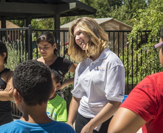Intern Camryn Agnello leads an ice-breaker game with children attending summer camp at Sacramento Food Bank & Family Services
