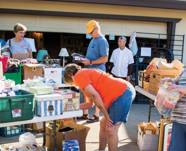 Visitors and shoppers mill about the annual Active 20-30 of Greater Sacramento No. 1032’s fundraiser garage sale, held this year in East Sacramento.