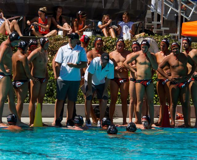 James Graham (white shirt, on right) coaches the men’s water polo team at the University of the Pacific.