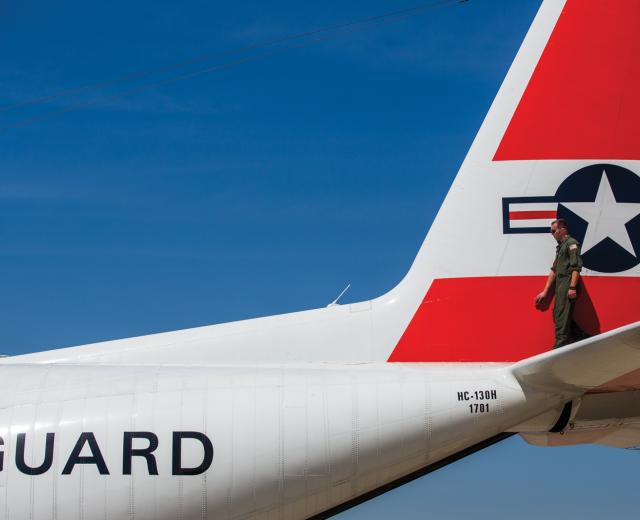 Avionics Electrical Technician Dan Boyd inspects a C-130 aircraft before it takes flight from the former McClellan Air Force Base.