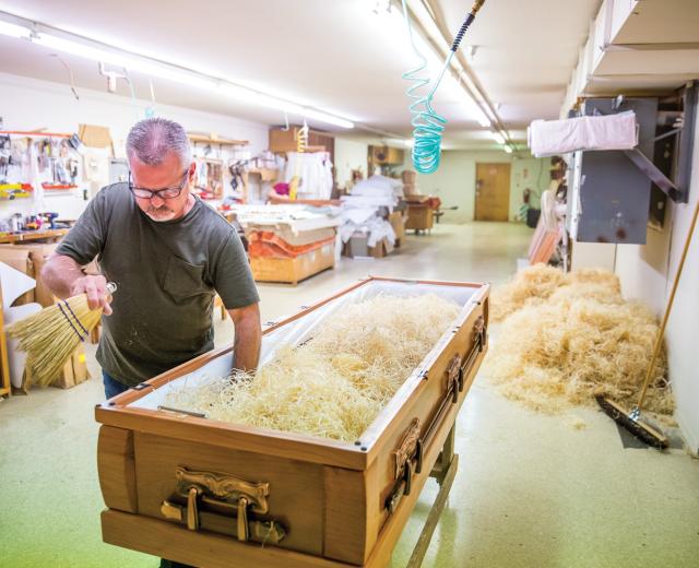 Jeff Pettigrew prepares the inside padding of a casket at Pettigrew & Sons Casket Co., a family-run business in Sacramento founded by the late Fay Pettigrew, who is Jeff’s grandfather. Building a casket is the last thing you can do for a person, says Barbara Pettigrew Hart, who is Fay’s daughter and Jeff’s aunt. “We think about, 'What if this was a person I love?'” 