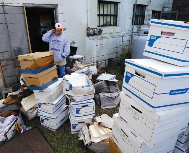 Certified Public Accountant John Sterling looks at damaged boxes of records removed from his Crisfield, Md. office after superstorm Sandy

(Photo by AP Photo / Alex Brandon)