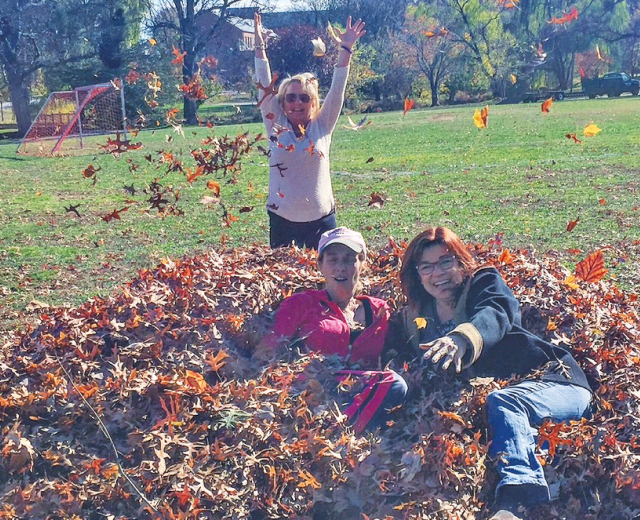 Comstock's Editor Judy Farah enjoys a New Jersey leaf pile with two longtime friends.
