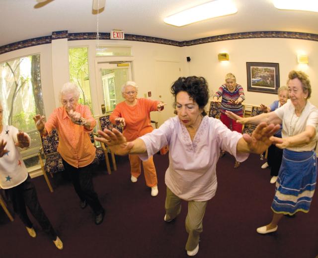 Residents of the Chateau at River's Edge participate in a Tai Chi class. 