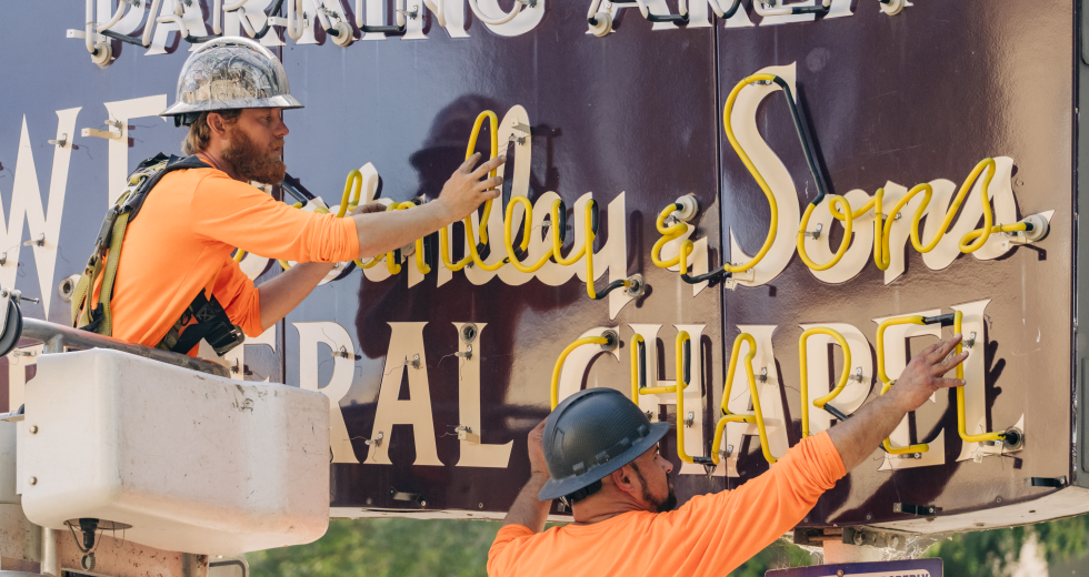 Workers detach the glass tubes from W.F. Gormley & Sons neon sign. (Photo by Francisco Chavira)
