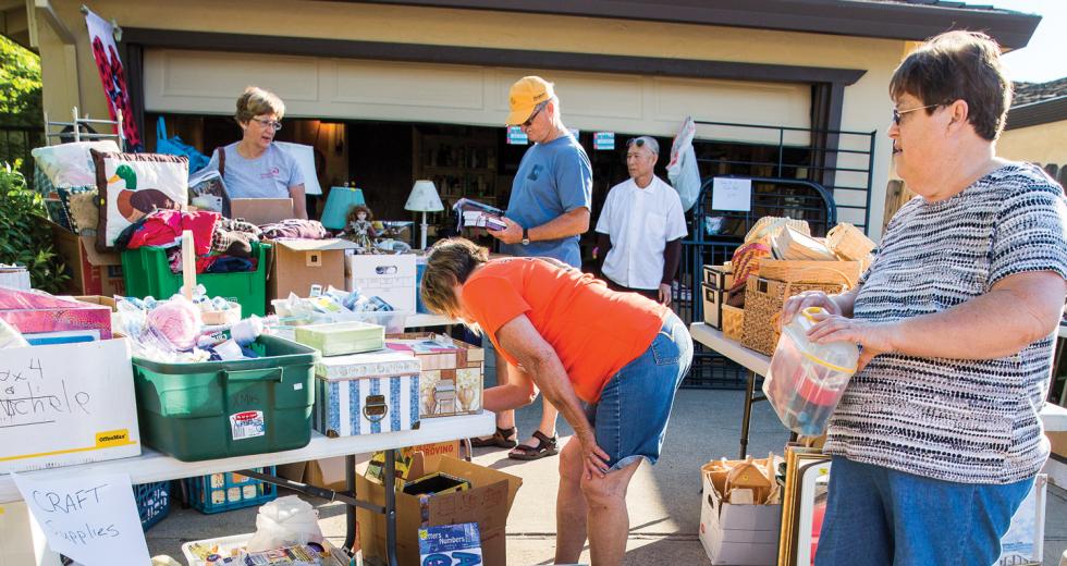 Visitors and shoppers mill about the annual Active 20-30 of Greater Sacramento No. 1032’s fundraiser garage sale, held this year in East Sacramento.