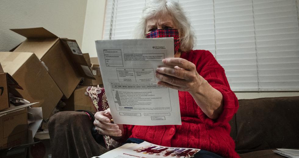 Nance Parry spends hours each day at home searching job listings on the internet and printed out lists of local job postings at her home in Duarte on Dec. 6, 2021. (Photo by Raquel Natalicchio for CalMatters)