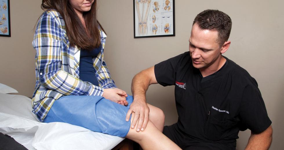 Dr. Hunter Greene, orthopedic surgeon, examines a patient at Summit Orthopedic Specialists in Carmichael.