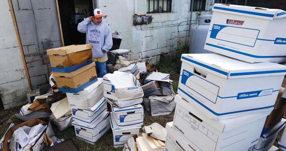 Certified Public Accountant John Sterling looks at damaged boxes of records removed from his Crisfield, Md. office after superstorm Sandy

(Photo by AP Photo / Alex Brandon)