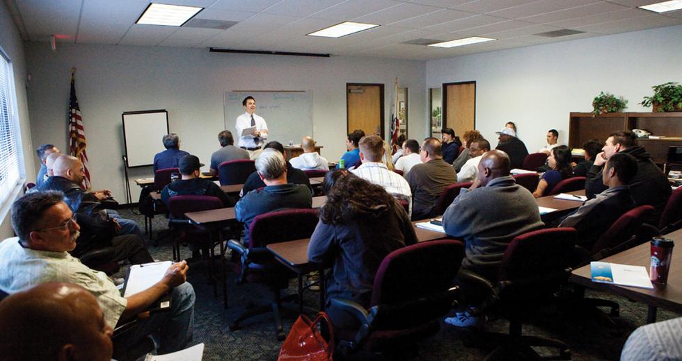 Unemployed San Joaquin residents gather at WorkNet to hear a seminar on building a resume. 