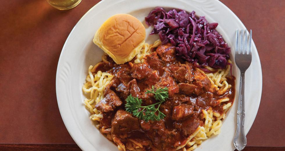 Hungarian pork sirloin goulash stewed with onion, garlic, paprika, caraway and red cabbage, served with spatzle and a pint of Warsteiner Pilsner