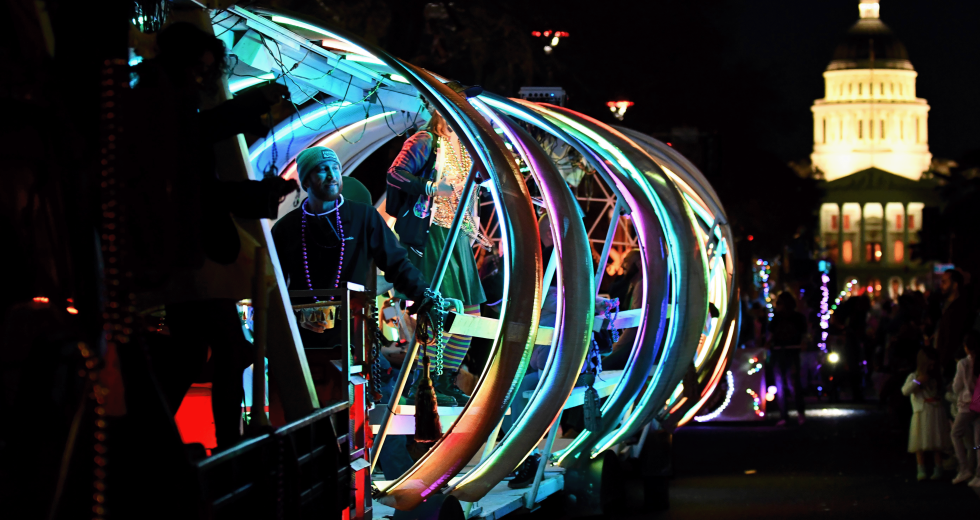 A glowing float passes in front of the state Capitol at the 2025 City of Trees Mardi Gras parade. (Courtesy photo)