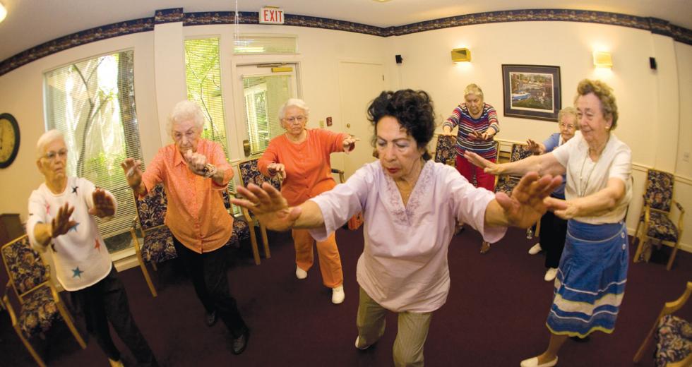 Residents of the Chateau at River's Edge participate in a Tai Chi class. 