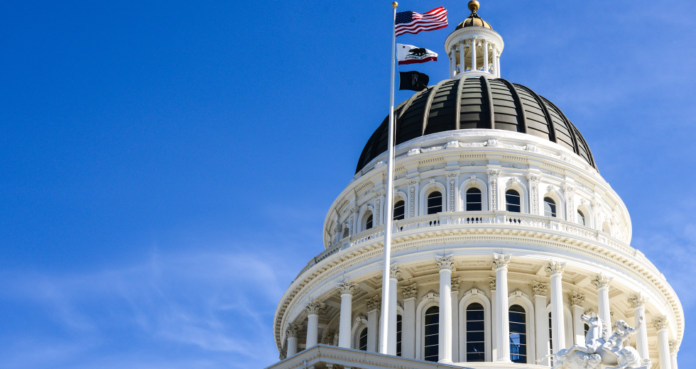The flags of the United States, the state of California and American Prisoners of War and those Missing in Action wave in front of the California state Capitol. (Shutterstock photo)
