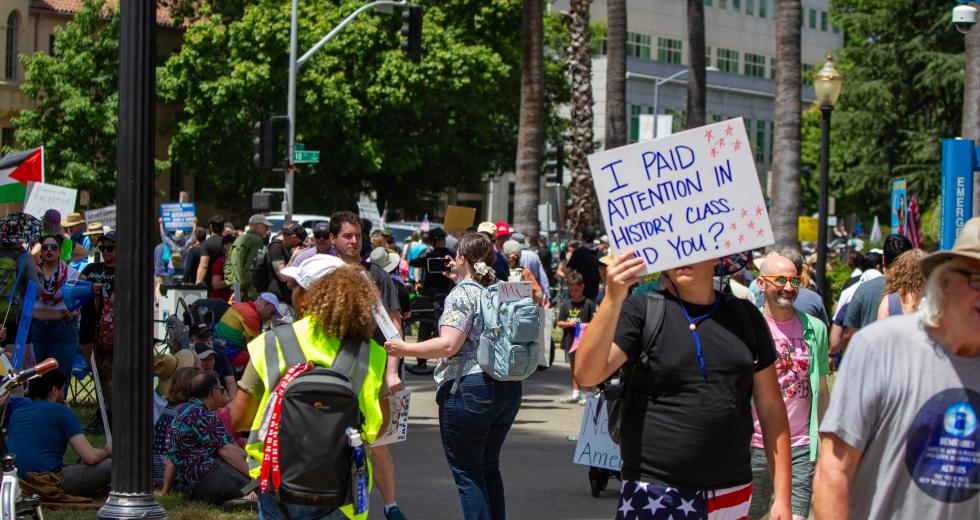 A protester holds a sign at the No Kings Rally in downtown Sacramento in June 2025. (Shutterstock photo)
