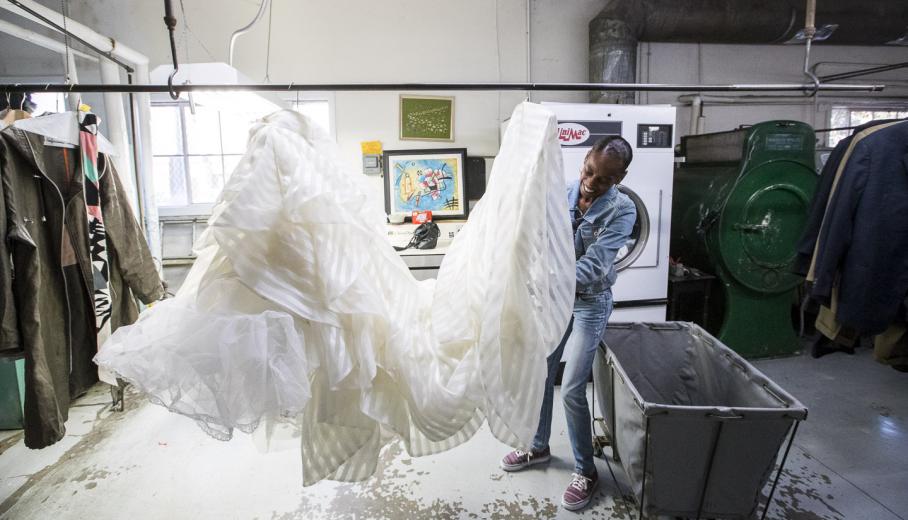 Phillips is also responsible for the especially tedious work of cleaning and pressing the wedding dresses for Woodard-Ficetti. Phillips spends about 30 minutes on the cleaning and an hour pressing a wedding gown, she says.