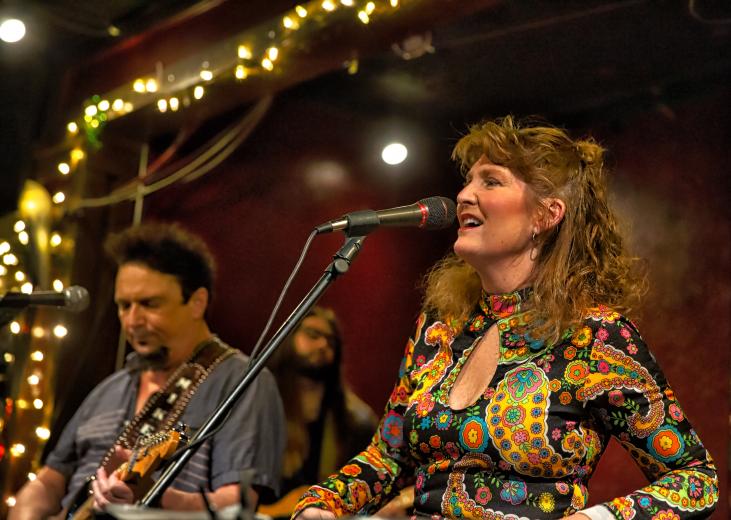 “Some people are into sewing; we’re into the blues,” says Blues in the Schools coordinator Lisa Phenix, performing at The Torch Club in Sacramento in February. Michael Roe is on the guitar to her right, with Matt Hevesh in the background. (Photo by Steve Martarano)
