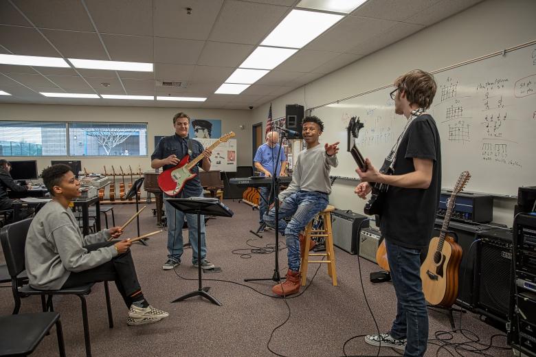 Drummer Amaya Levels, guitarist Anthony Galli, teacher Steve Boettner (on the keyboard), vocalist Jacquez Cosby and guitarist Clinton Jones practice for the upcoming band showcase on May 2. (Photo by Steve Martarano)