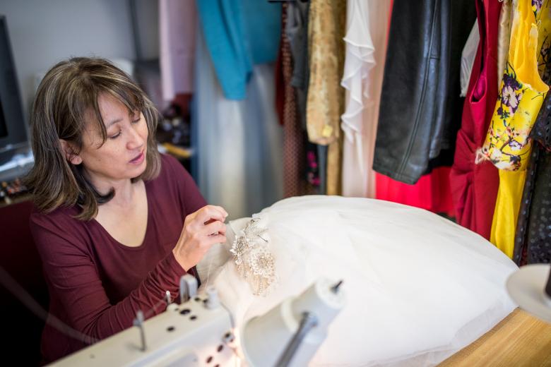In addition to bridal gowns, Johng-Nishikawa works on evening gowns and even theater costumes for a local high school. She opened the brick-and-mortar location in September 2017, her and her husband’s home having long been taken over by sequins and sewing materials. Her team now includes one employee and an intern.