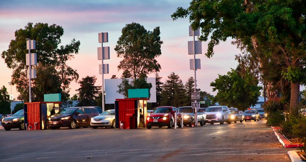 At sunset, vehicles enter the West Wind Drive-In lot and head to one of the six theaters.