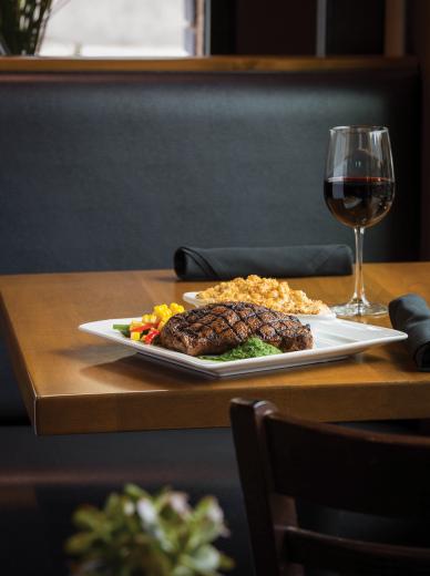 At The Independent, dry-rubbed, ancho-crusted ribeye with housemade chimichurri, vegetables and truffle mac and cheese. Paired with a 2010 Sierra Foothills Windwalker Vineyard Zinfandel