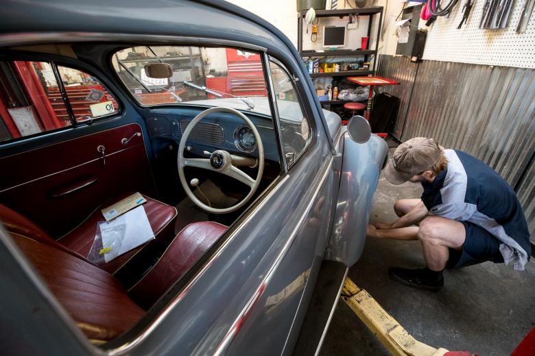 Technicians work interchangeably between the two repair departments and seven car lifts. Air-cooled engines were a signature trait of VW autos when the German automaker started in 1937, before the company transitioned to primarily water-cooled engines by the ‘80s. Above technician Cody Gee works on an air-cooled 1956 Volkswagen Beetle with a right-side steering wheel originally imported from Germany and assembled in Australia.