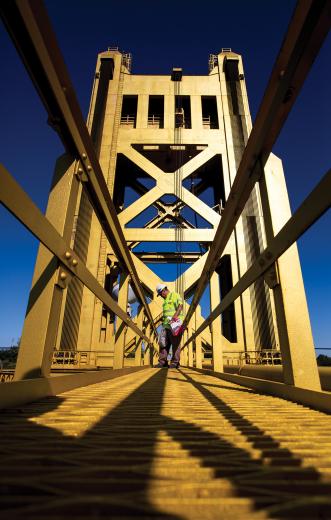 Scott Bennett walks along the catwalk of Tower Bridge, cleaning the spotlights and doing a general visual inspection. Scott Bennett walks along the catwalk of Tower Bridge, cleaning the spotlights and doing a general visual inspection.