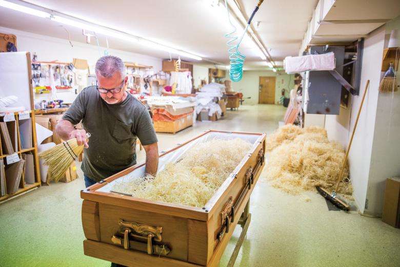 Jeff Pettigrew prepares the inside padding of a casket at Pettigrew & Sons Casket Co., a family-run business in Sacramento founded by the late Fay Pettigrew, who is Jeff’s grandfather. Building a casket is the last thing you can do for a person, says Barbara Pettigrew Hart, who is Fay’s daughter and Jeff’s aunt. “We think about, 'What if this was a person I love?'” 