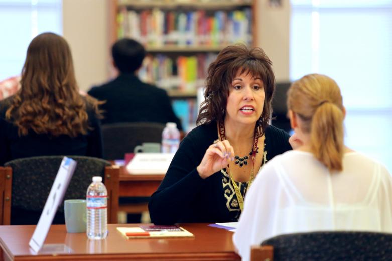 Volunteer Molly Anderson gives advice to senior Trinity Downs during her mock interview.