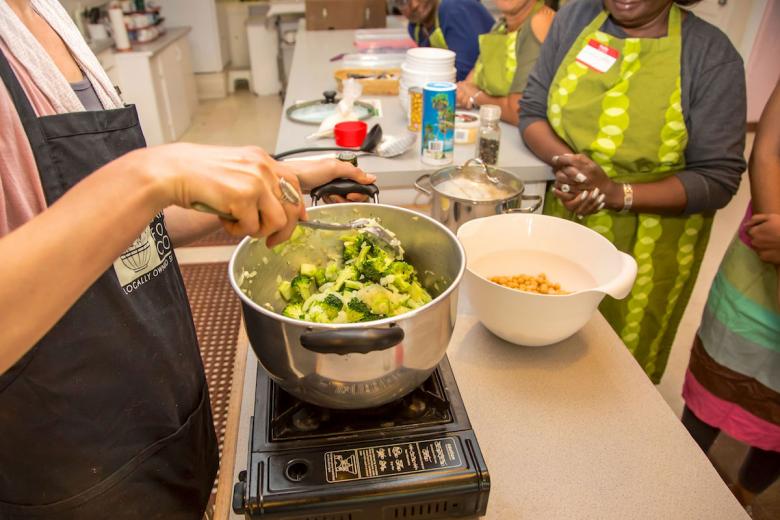 Sarah Moody sautés fresh vegetables as the program participants look on. “You can tell people what to do but until they go through it themselves, they don't know how easy or accessible it is,” Moody says. Sarah Moody sautés fresh vegetables as the program participants look on. “You can tell people what to do but until they go through it themselves, they don't know how easy or accessible it is,” Moody says.