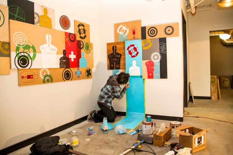 Hart uses paint to complete her "Don't Shoot" installation for the R Street lobby Hart uses paint to complete her "Don't Shoot" installation for the R Street lobby