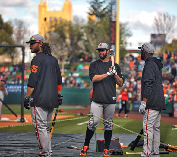 Giants players Brandon Crawford, Evan Longoria and Austin Jackson wait for their turns in the cage during batting practice.