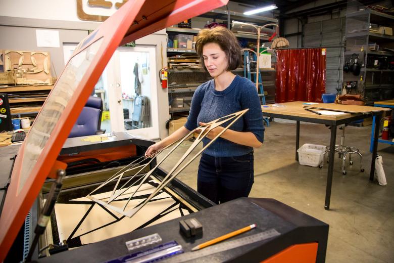 Dana Iske cuts colored plexiglas for her installation in the 4th floor elevator lobby Dana Iske cuts colored plexiglas for her installation in the 4th floor elevator lobby