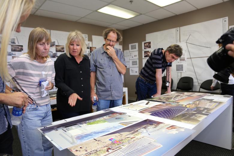 Artist Lynn Criswell (left) talks with SMAC Executive Director Shelly Willis about arena plans as fellow artists Michael Bishop and Scott Minneman peruse drawings. Artist Lynn Criswell (left) talks with SMAC Executive Director Shelly Willis about arena plans as fellow artists Michael Bishop and Scott Minneman peruse drawings.