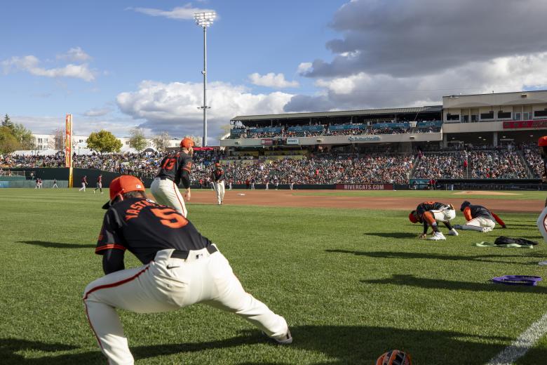 Giants players stretch on the field before the exhibition game matchup with the River Cats at a sold-out Sutter Health Park on March 24.
