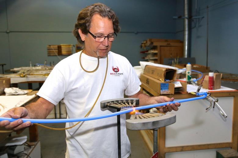 Neon bender Steve Uroff shaped new glass tubes and filled them with argon, which glows red. Neon bender Steve Uroff shaped new glass tubes and filled them with argon, which glows red.