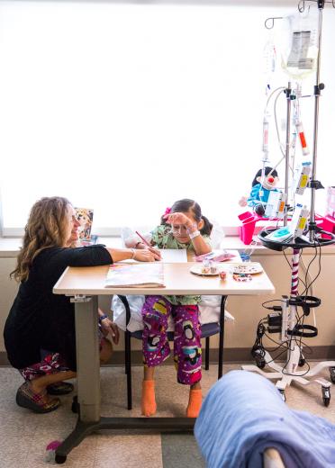 Castles works with Leilany Martinez, a second-grader, on math and spelling. Martinez, who was hospitalized with appendicitis, is more of a short-term patient. Castles works with Leilany Martinez, a second-grader, on math and spelling. Martinez, who was hospitalized with appendicitis, is more of a short-term patient.