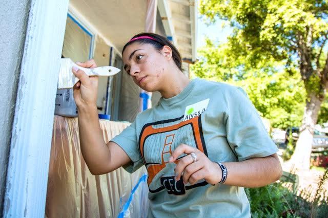 Alyssa Carrillo touches up white paint on the trim. Approximately 150 volunteers turned out for Paint the Town, designed to give a face-lift to neighborhoods like South Oak Park. Alyssa Carrillo touches up white paint on the trim. Approximately 150 volunteers turned out for Paint the Town, designed to give a face-lift to neighborhoods like South Oak Park.