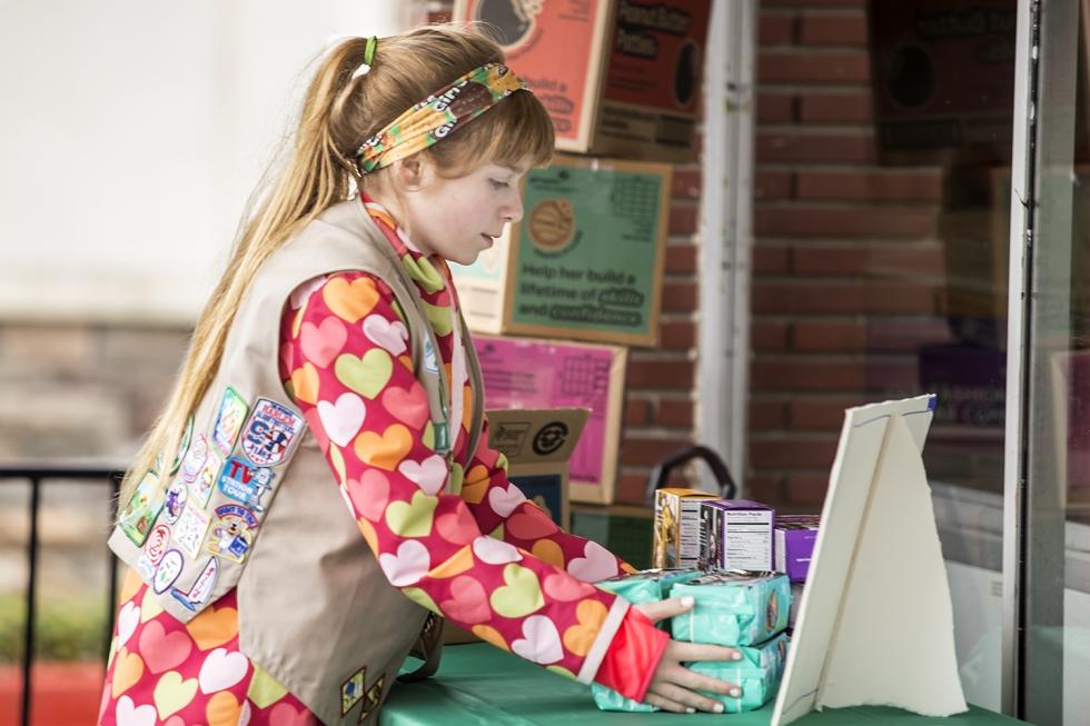 Claire Simon arranges Girl Scout cookies for sale outside Burr’s.
