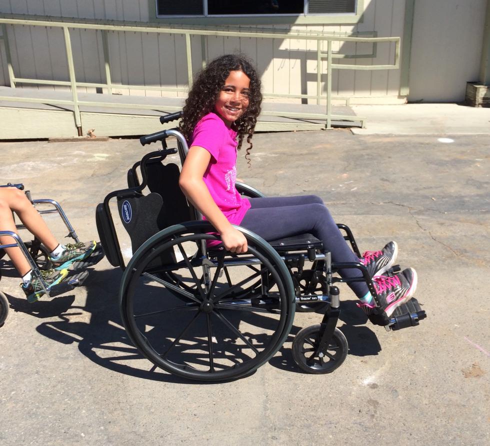 A 4th grade student experiences a wheelchair during a workshop held by A Touch of Understanding. (Photo courtesy Meghan Adamski)
