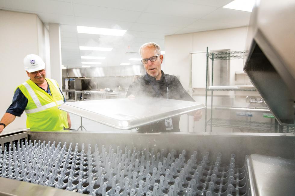 Executive Chef Michael Tuohy (right) and Project Manager Michael Papa watch as the first pan ever is washed in the central kitchen of the new Golden 1 Center.