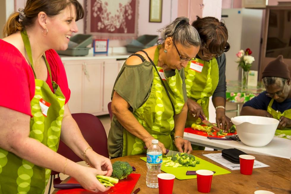 Leah Yadon (left), Vivian Walthall and Fredonia Phillips chop broccoli during the cooking demonstration at the Co-Op Community Kitchen.
