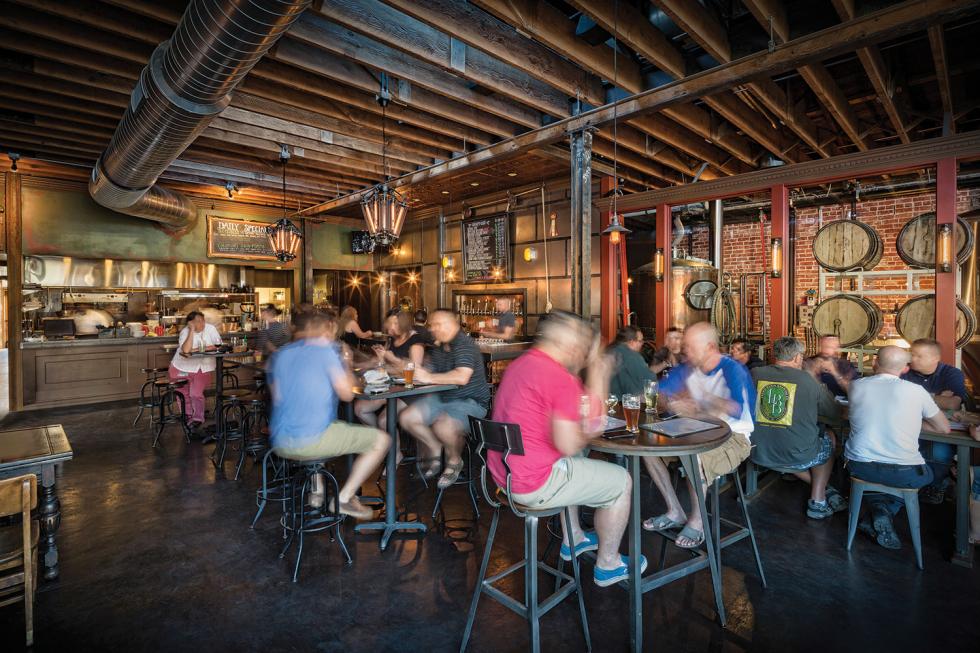 Oak Park Brewing Co.’s interior dining space melds the historic elements of the building with modern taste; dark woods complement copper and glass for a comfortable yet utilitarian feel.
